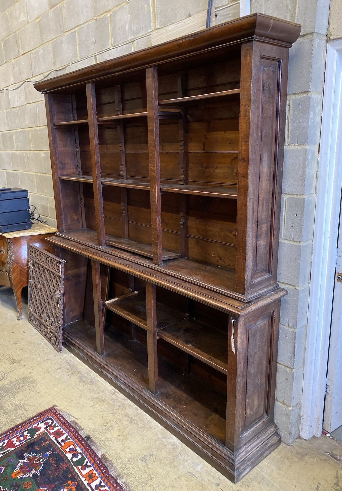 An early 20th century oak open bookcase, width 198cm, depth 38cm, height 210cm